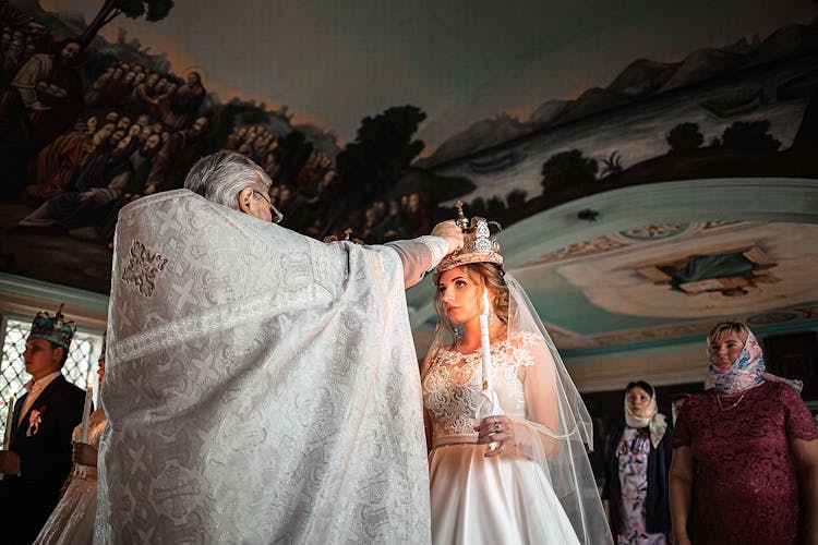 Priest Performing Wedding Ceremony In Church