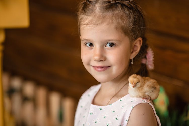 Cute Girl With Chick On Shoulder