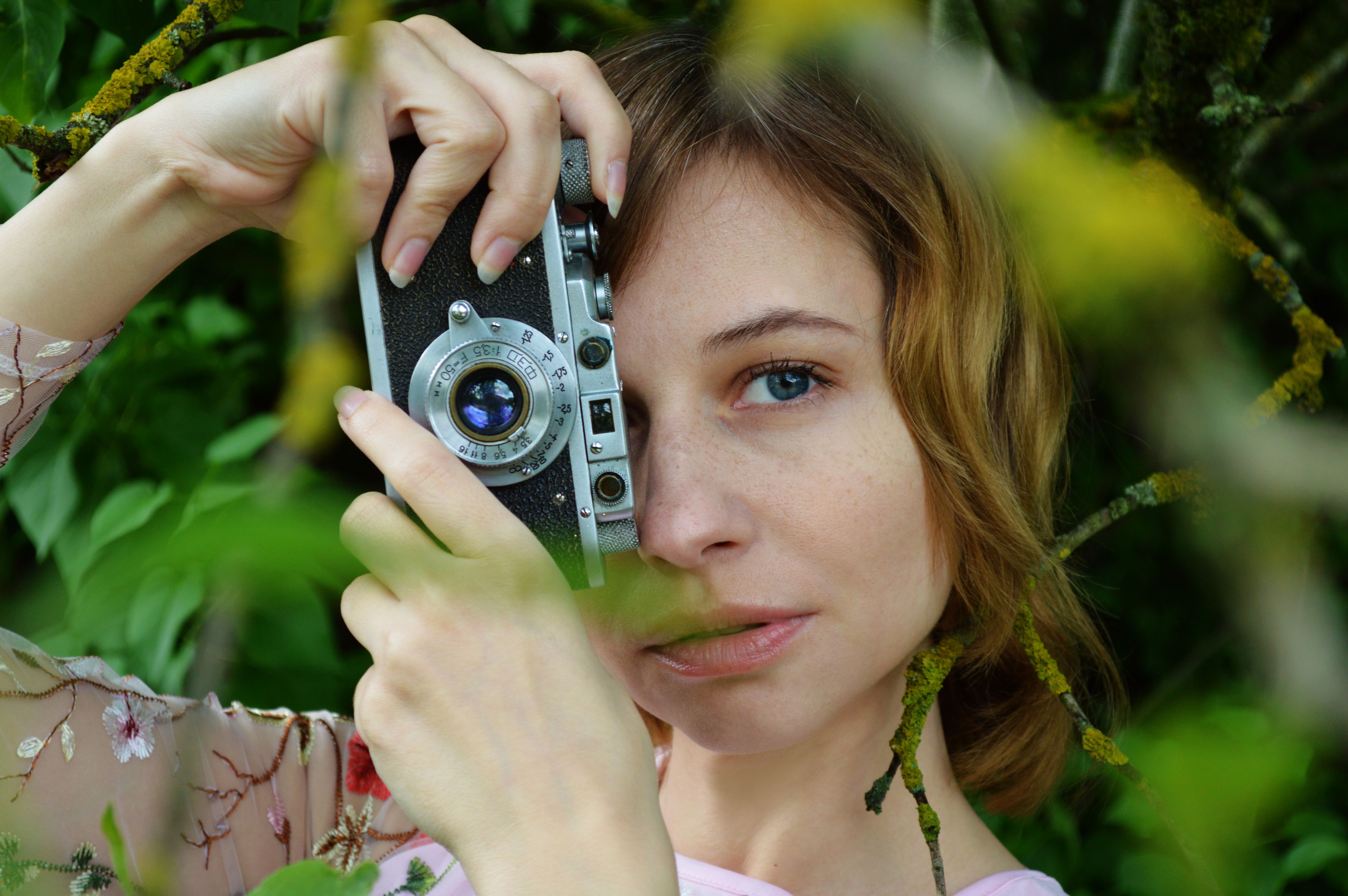 Asian photographer shooting street from balcony window · Free Stock Photo