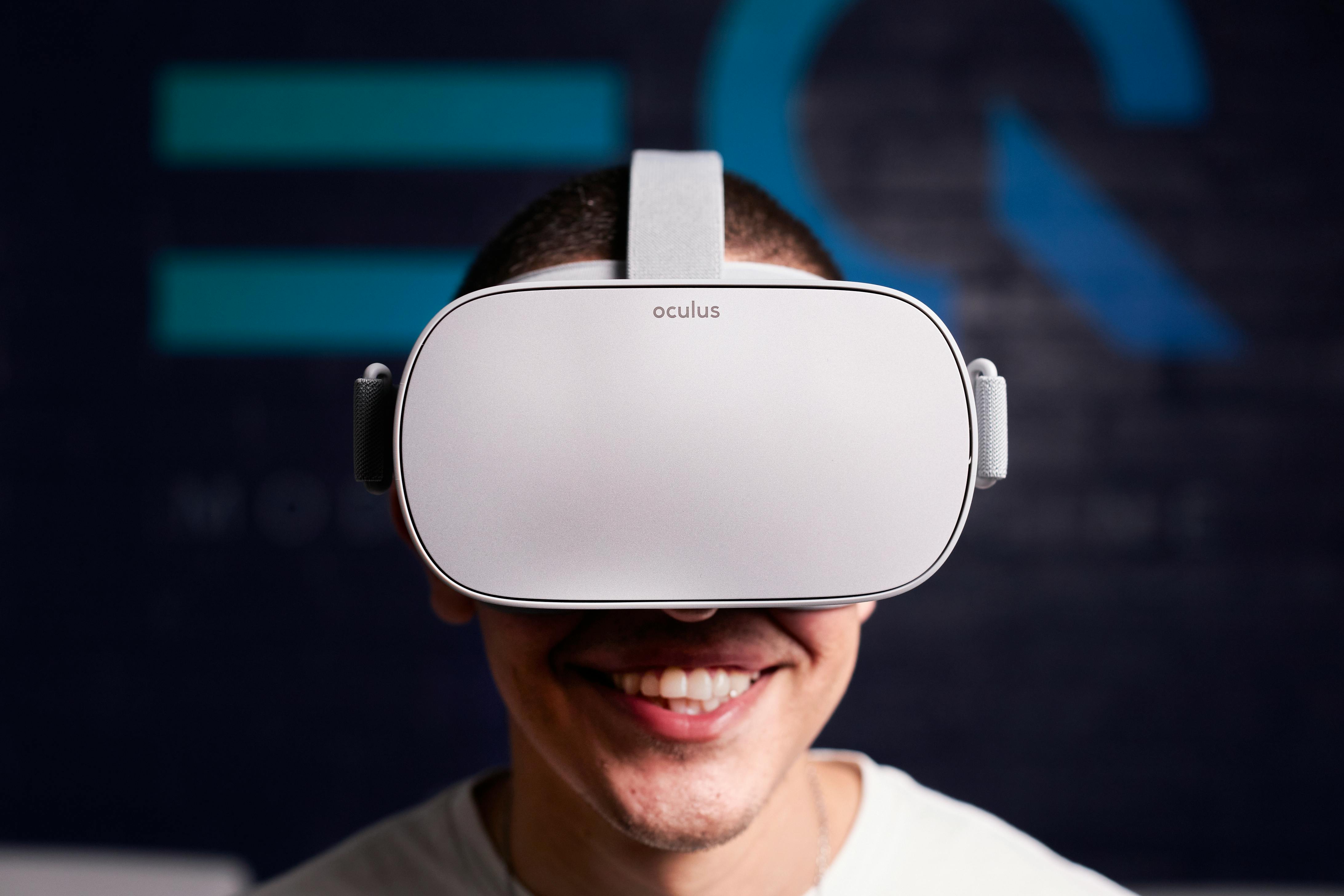 man in white crew neck shirt wearing white and black vr goggles