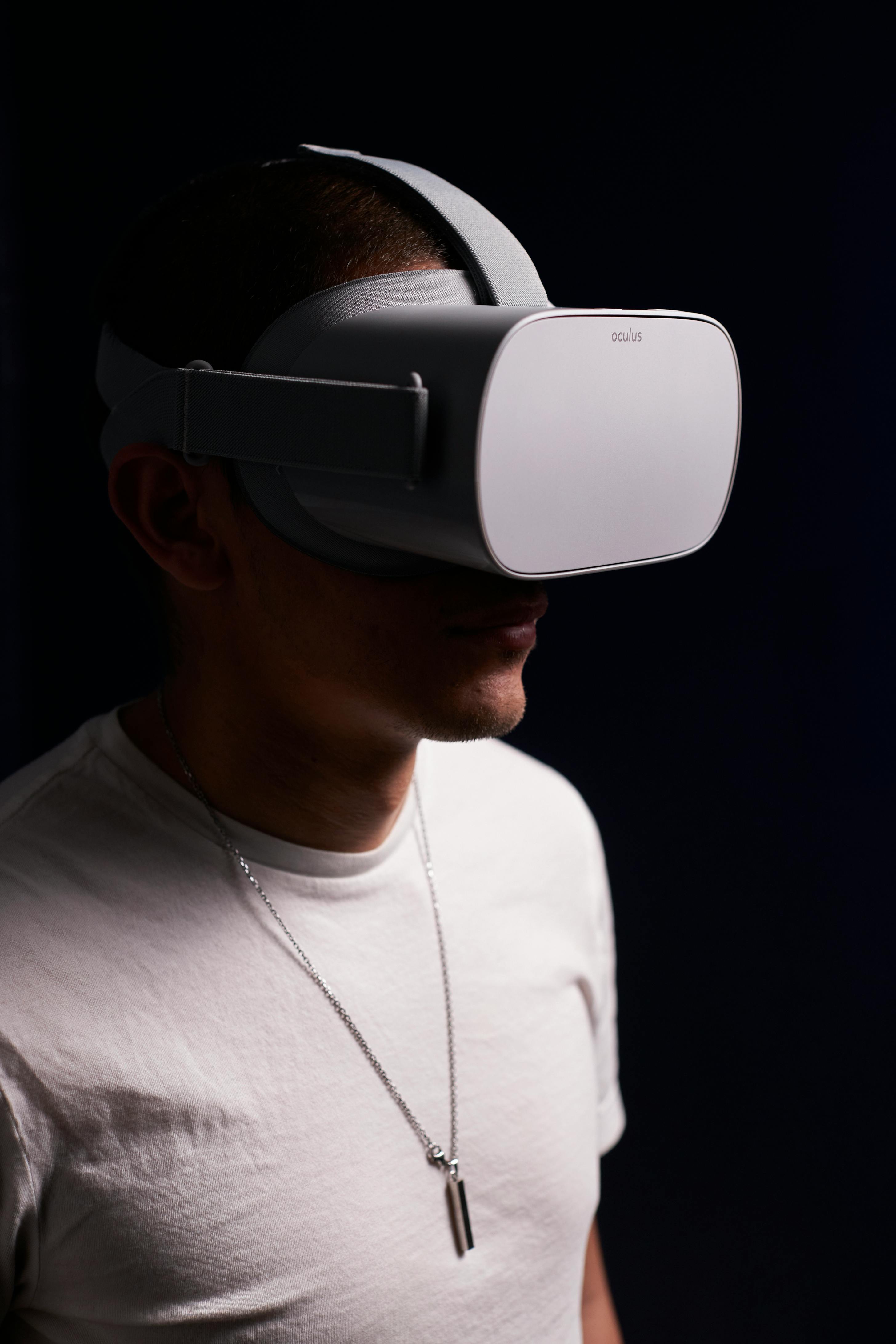 man in white t shirt wearing gray vr goggles