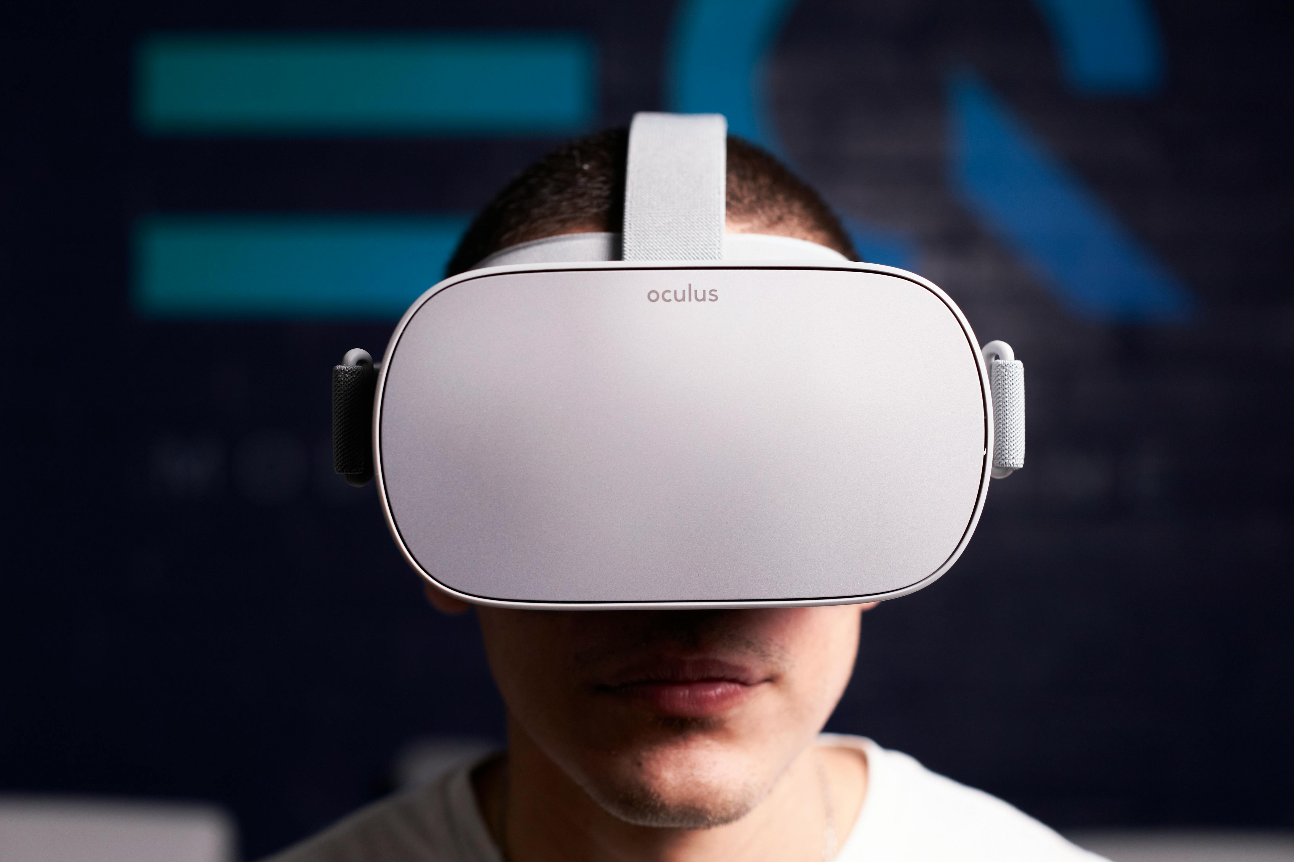 close up shot of man using white oculus vr goggles