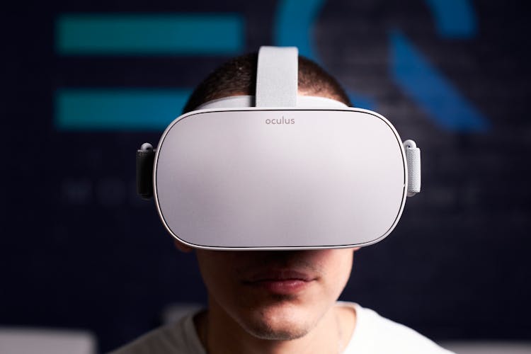 Close-Up Shot Of Man Using White Oculus VR Goggles