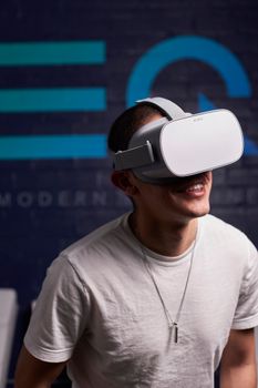 A joyful moment captured as a man engages with virtual reality tech indoors.