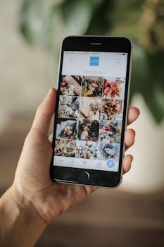 Close-up of a hand holding a smartphone displaying a floral image gallery app interface.