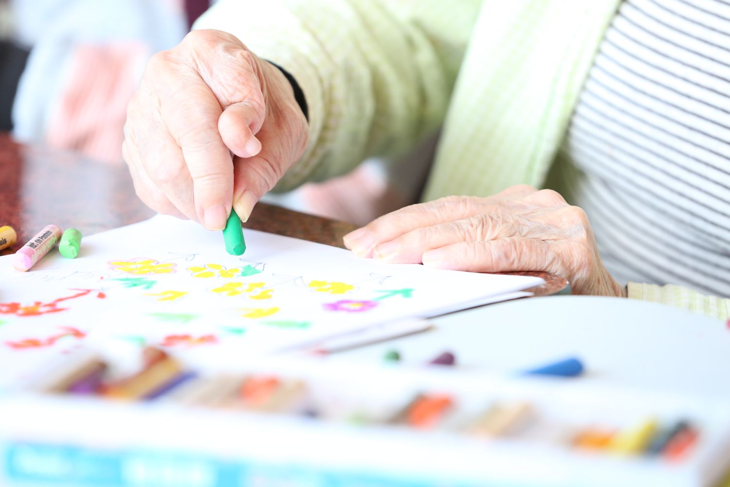 Senior resident engaging in therapeutic activity in a bright activity room