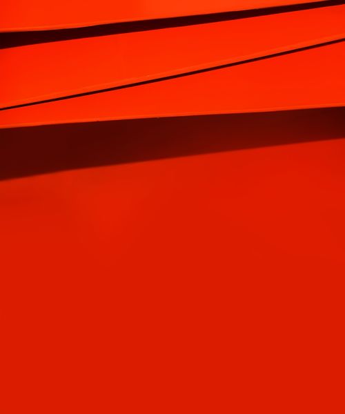 Free A vibrant red abstract image featuring dynamic geometric shapes and lines. Stock Photo