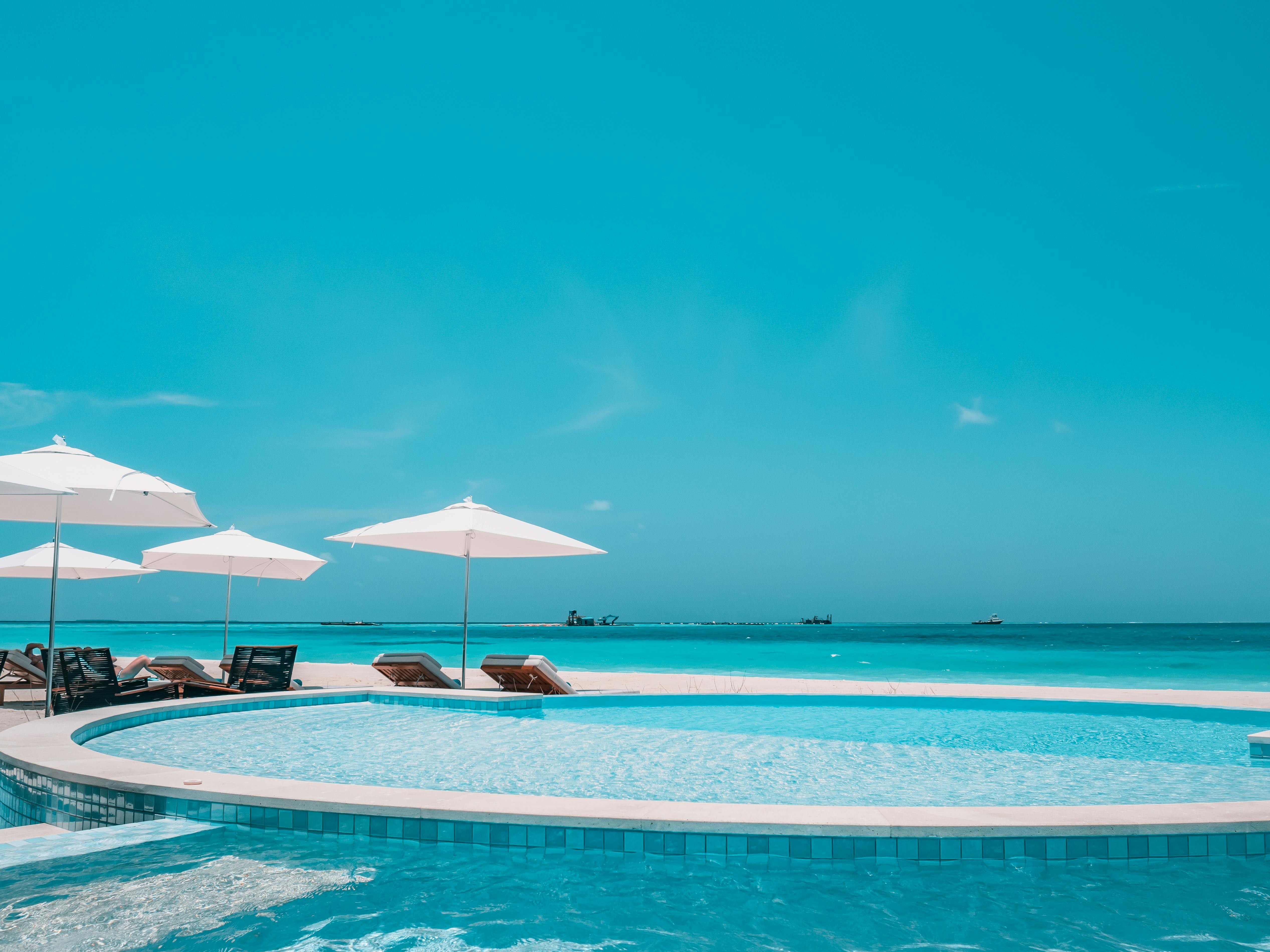 Luxurious poolside with ocean view, perfect for a tropical vacation getaway.