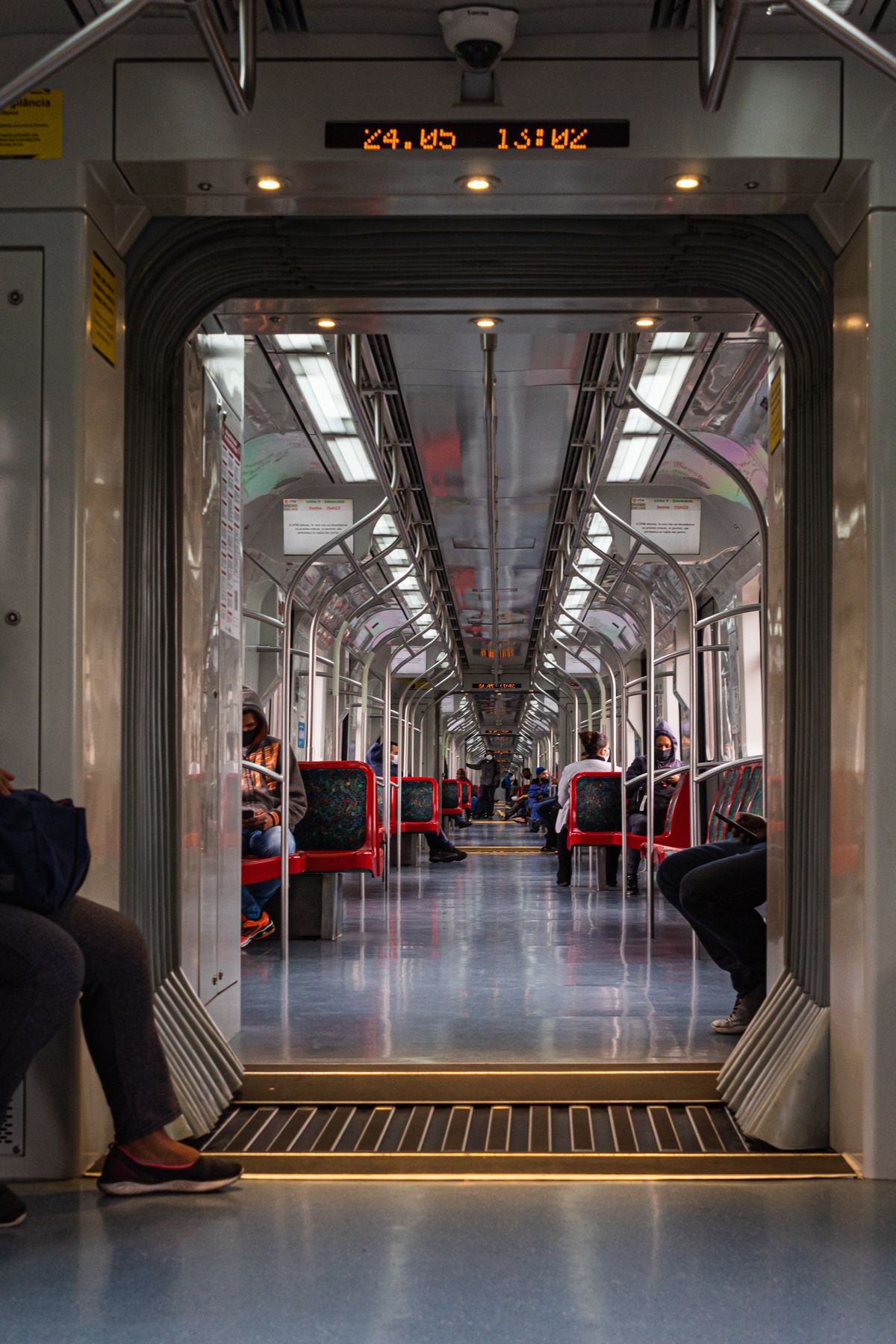 An interior view of a modern train with seated passengers during a journey