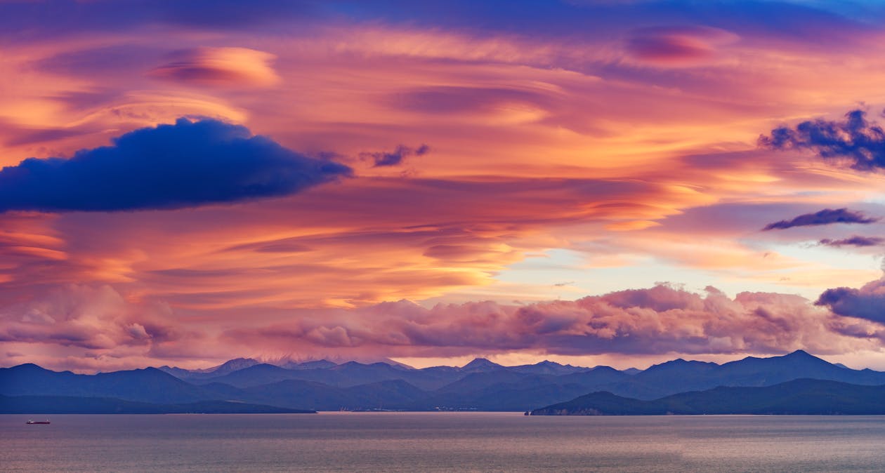 Majestic sunset sky above mountains and sea