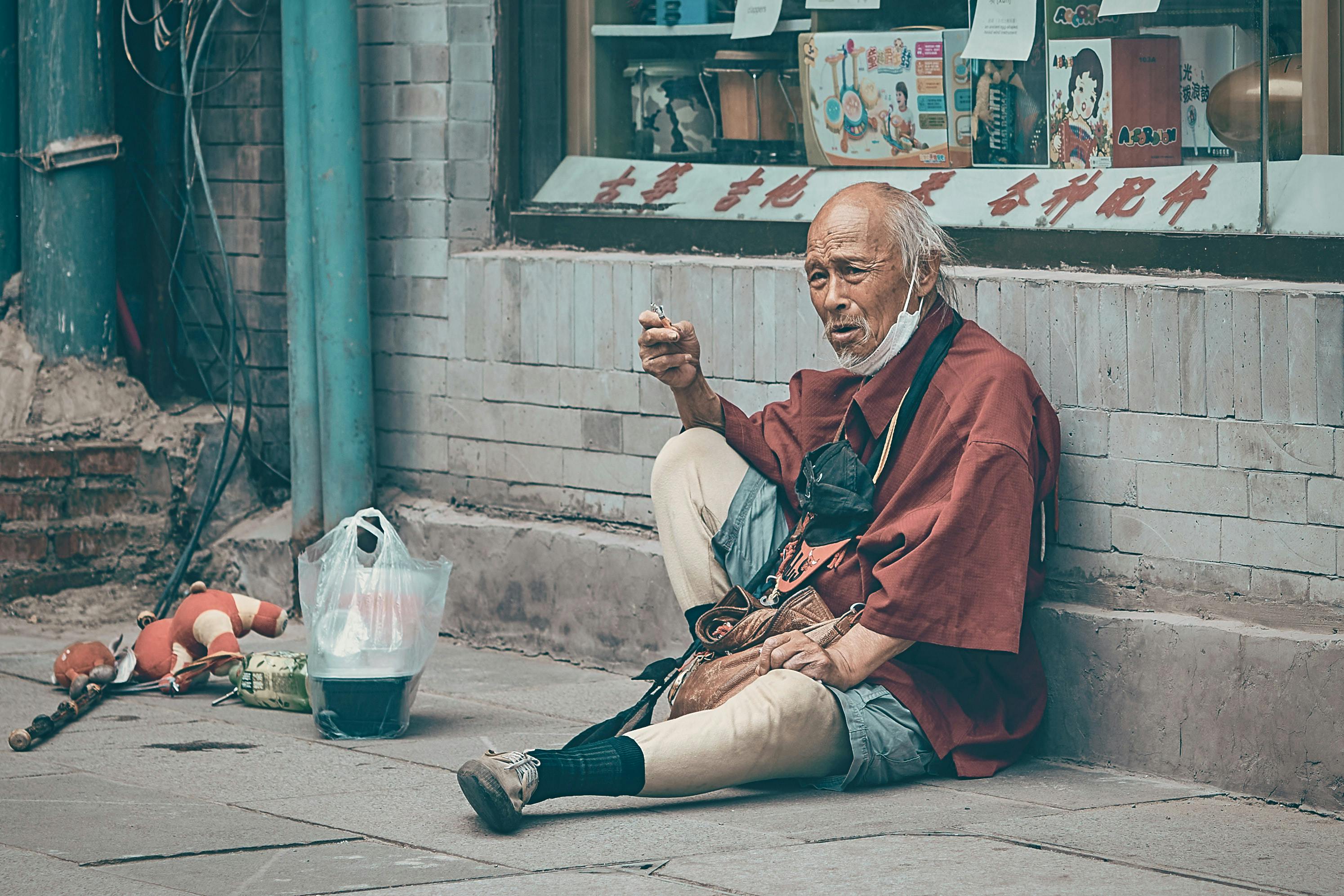 Man in Red Robe Sitting on Floor