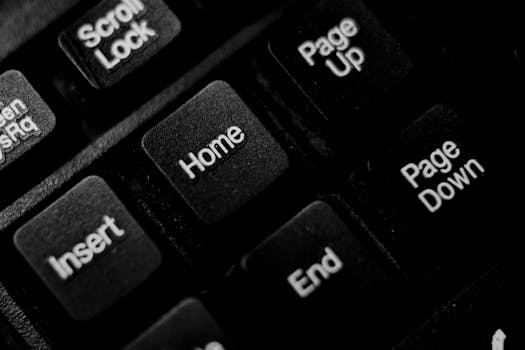 Detailed close-up image of black plastic computer keyboard keys in monochrome.