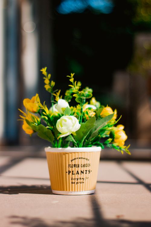 Free Charming artificial flowers in a stylish pot, perfect for brightening up any indoor space. Stock Photo