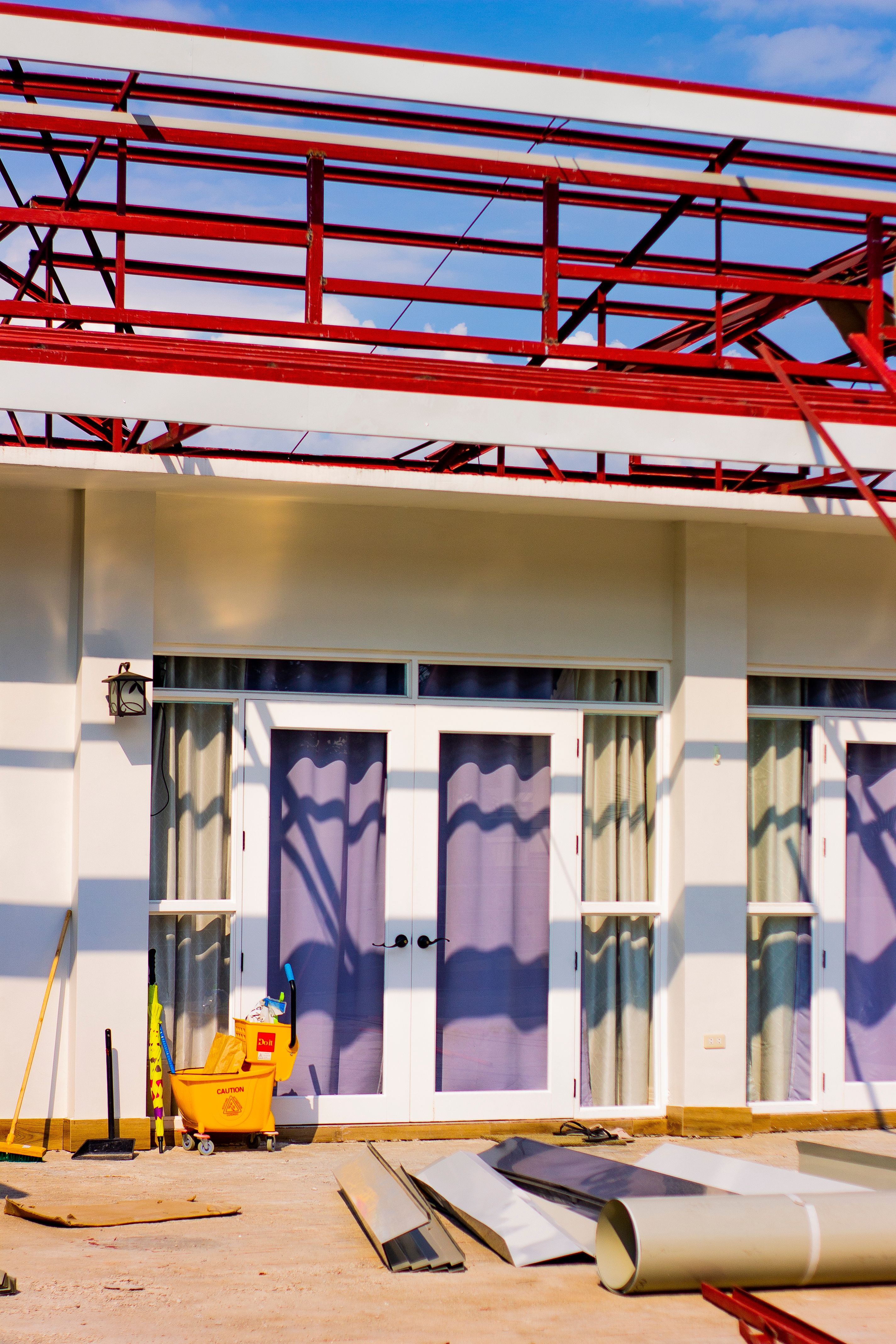 Construction materials and scaffolding outside a home during a major remodeling project.
