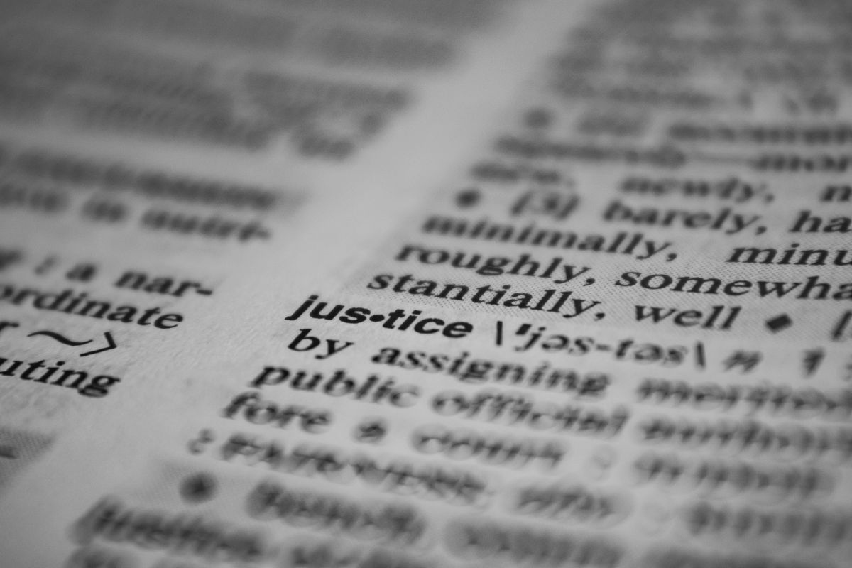 Close-up of an open dictionary page with printed word definitions