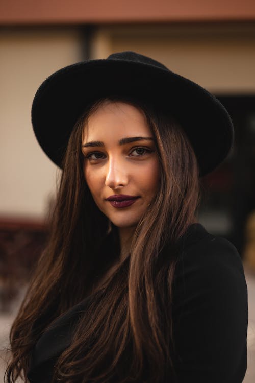 A Beautiful Woman Wearing a Black Hat 
