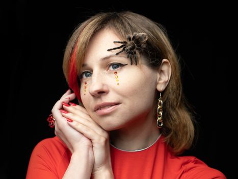 Spooky spider on face of young woman