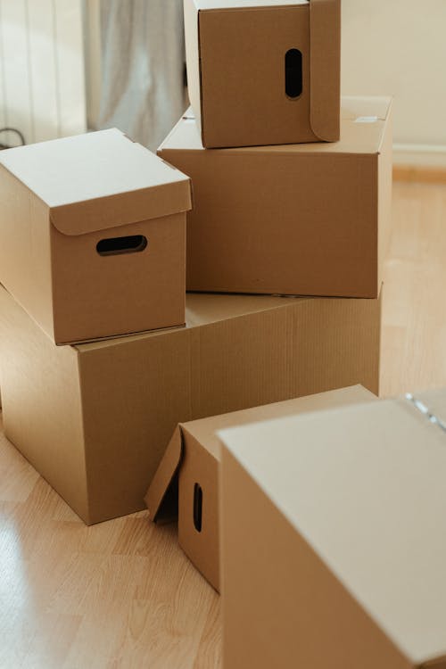 Brown Cardboard Box on Brown Wooden Table