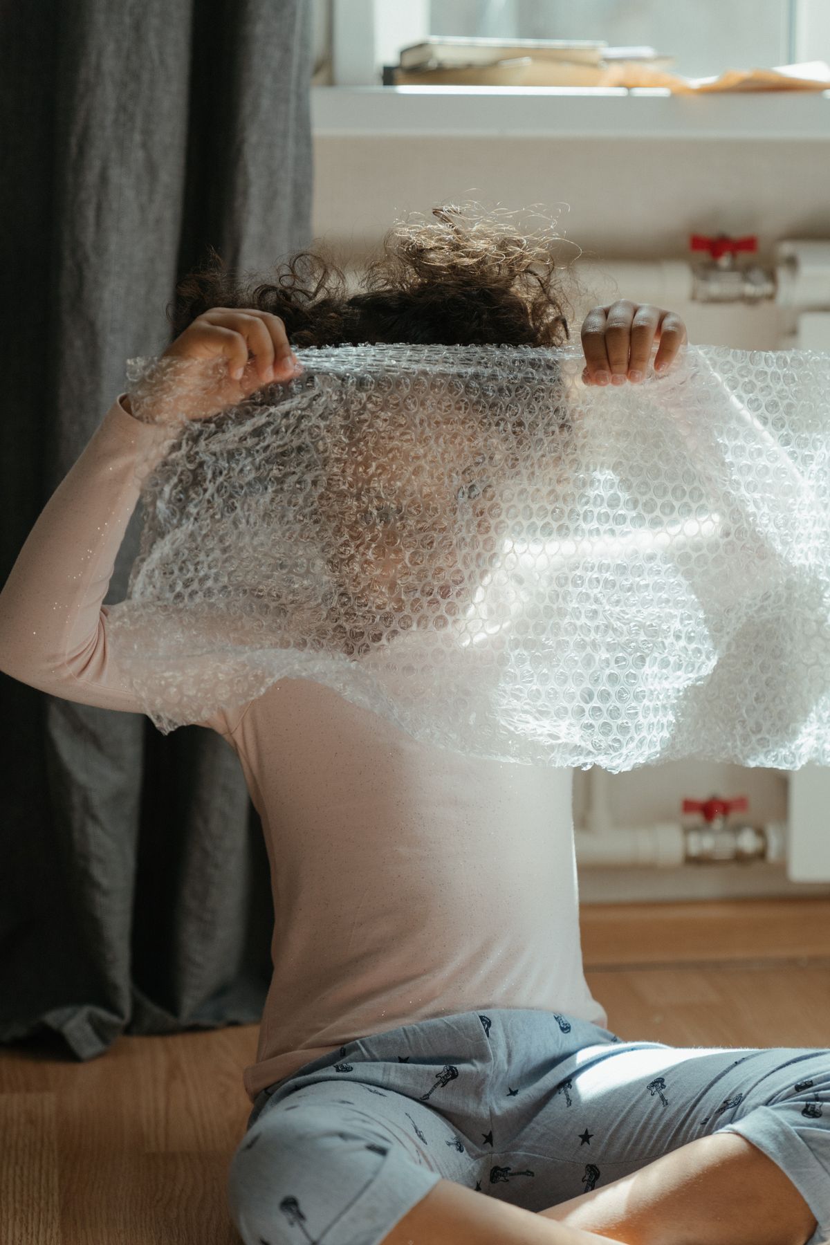 Child holding a sheet of bubble wrap