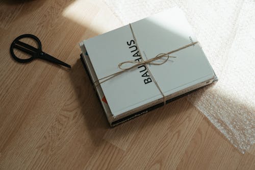 Free White Box With Black Pen on Brown Wooden Table Stock Photo