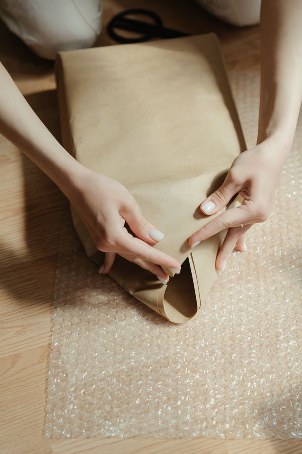 Kraft paper being used to wrap a package