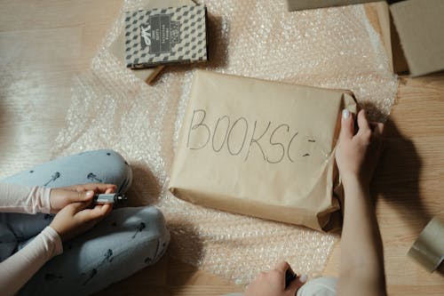 White and Black Card on Brown Paper Bag