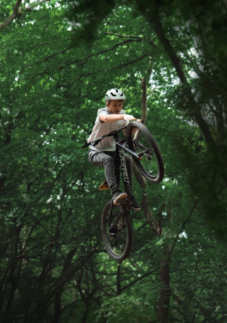 
A Man Riding His Mountain Bike Doing A Stunt