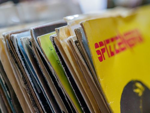 Free Colorful vintage vinyl record sleeves stacked together with a blurred background. Stock Photo