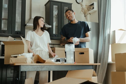 Man in Black Crew Neck T-shirt Standing Beside Woman in White Crew Neck T-shirt