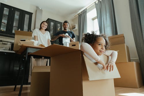 Free Little Girl Playing in a Box Stock Photo