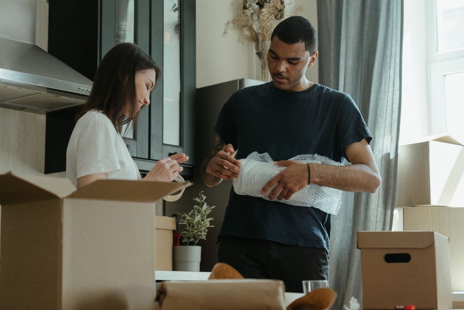 couple packing cardboard boxes