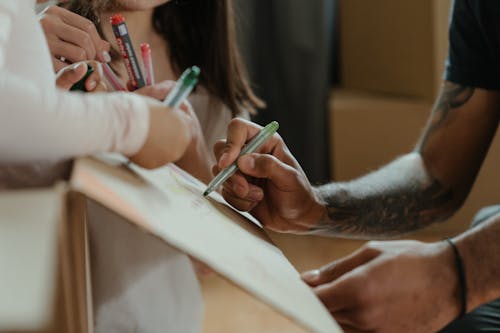 Person Writing on White Paper