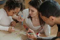 一家人一起在纸板上画画，表达创造力，共度美好时光