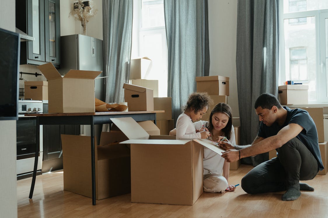 Free Family Unpacking After Moving Stock Photo