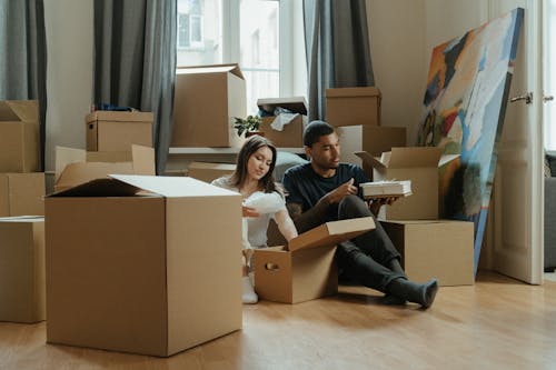 2 Boys and Girl Sitting on Brown Cardboard Box