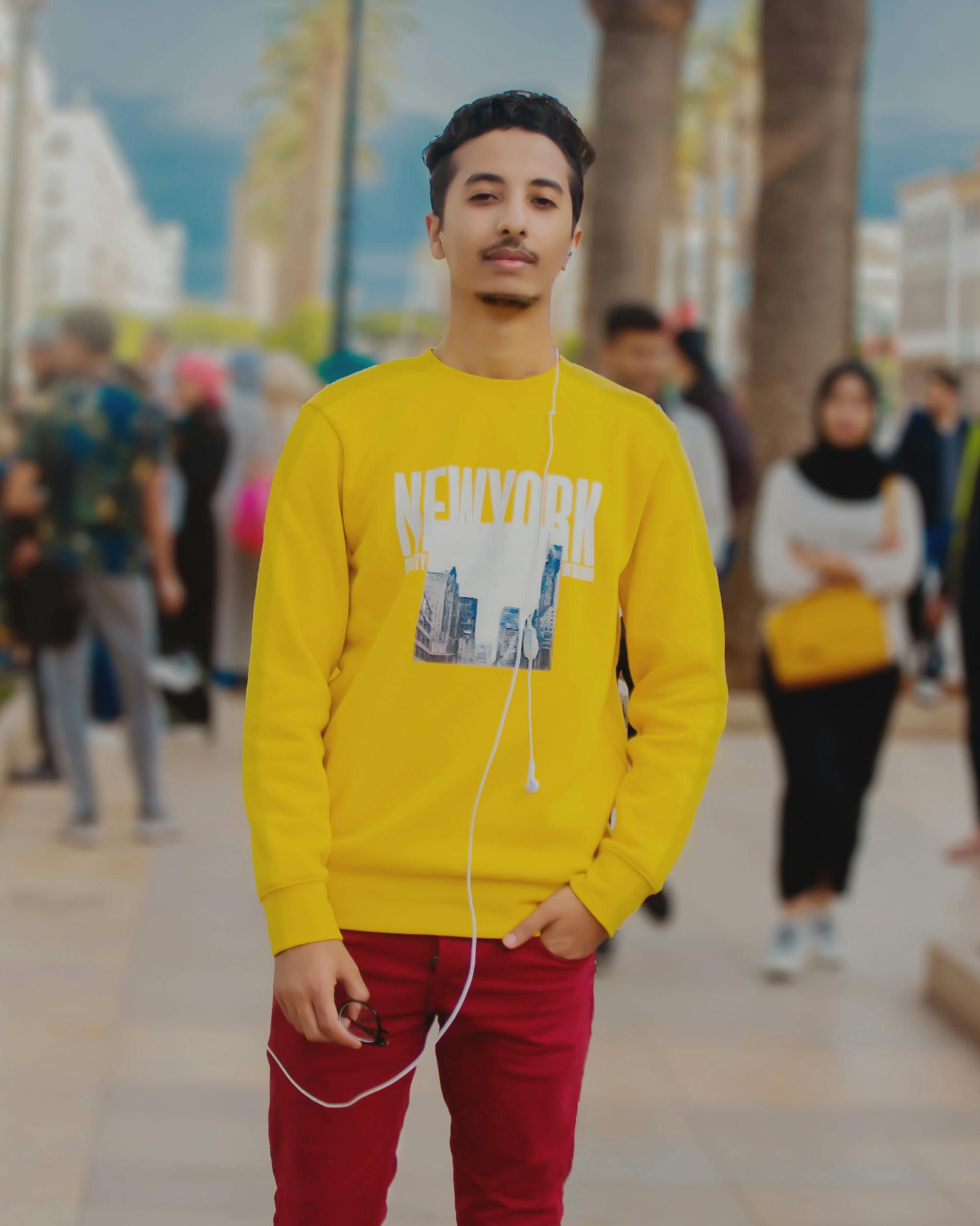Happy couple standing near their insured car receiving keys from an agent