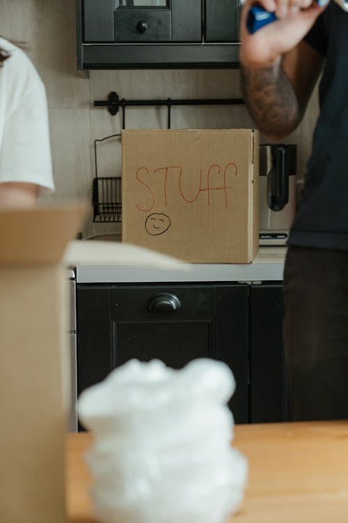 Man in White Shirt Standing Beside Kitchen Sink