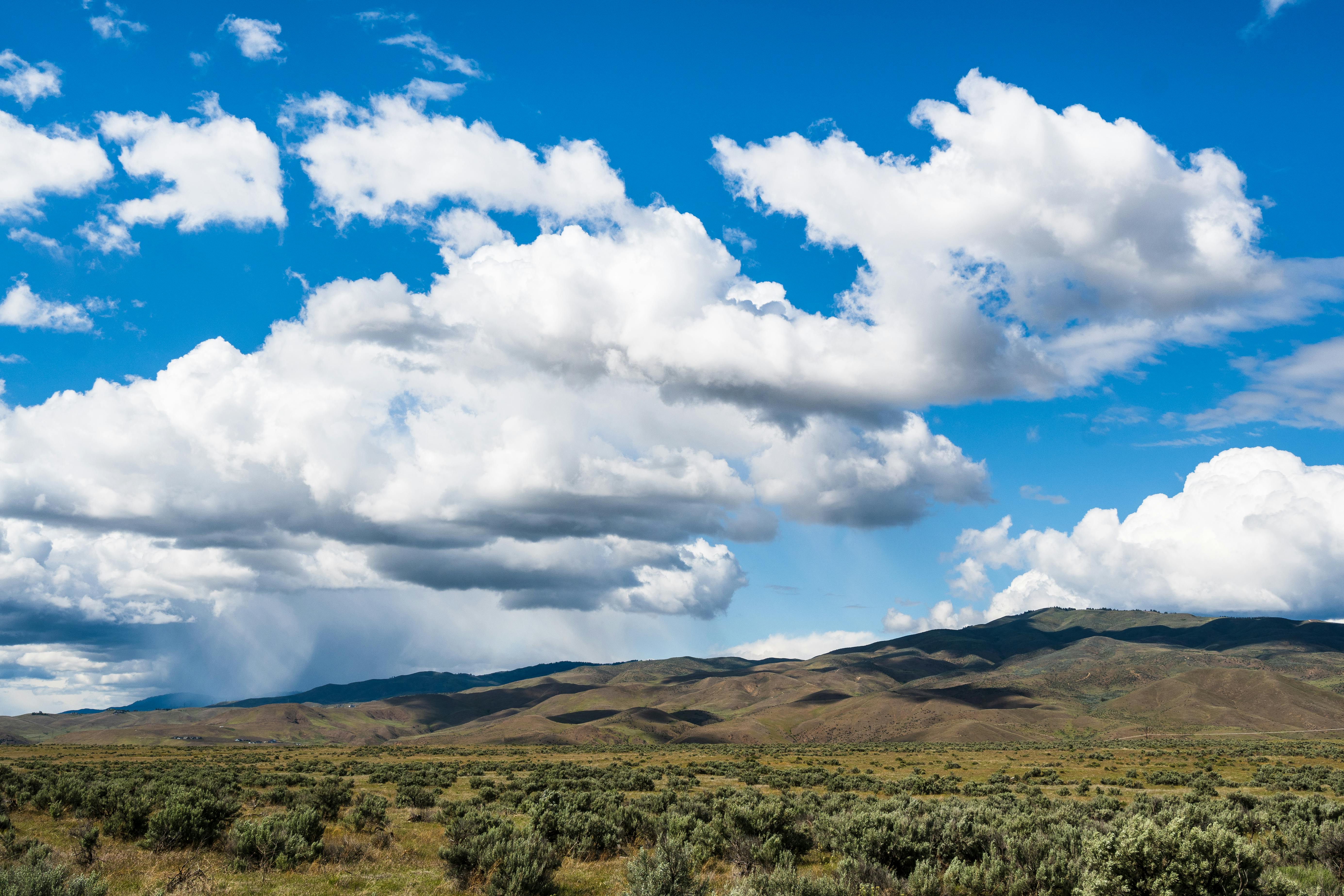Green Grass Field Under White Clouds And Blue Sky Free Stock Photo