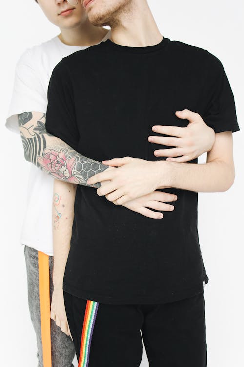 Free Man Hugging Another Man from Behind Stock Photo