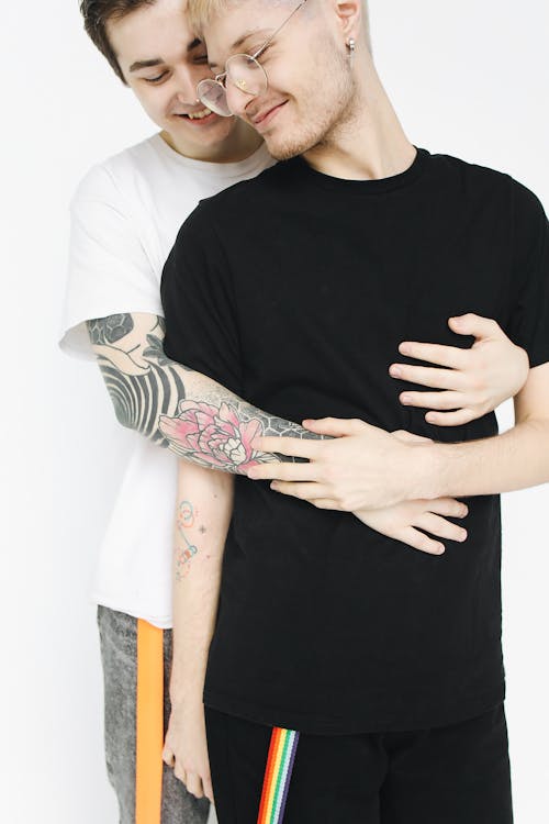 Free Man Hugging Another Man from Behind Stock Photo