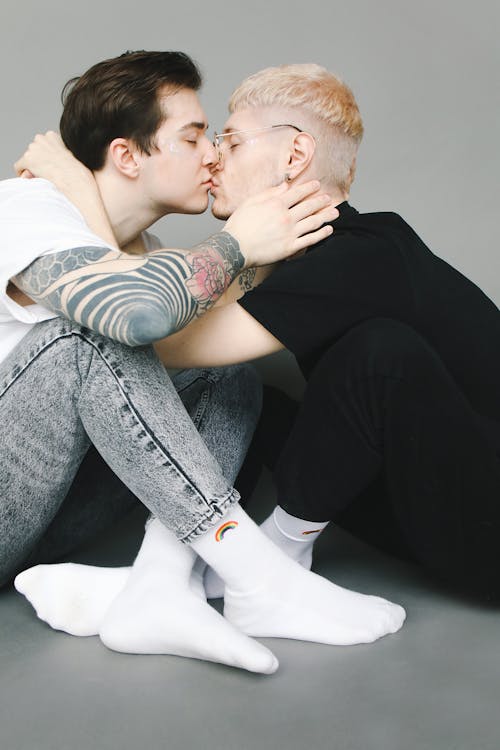 Men Sitting on the Floor and Kissing