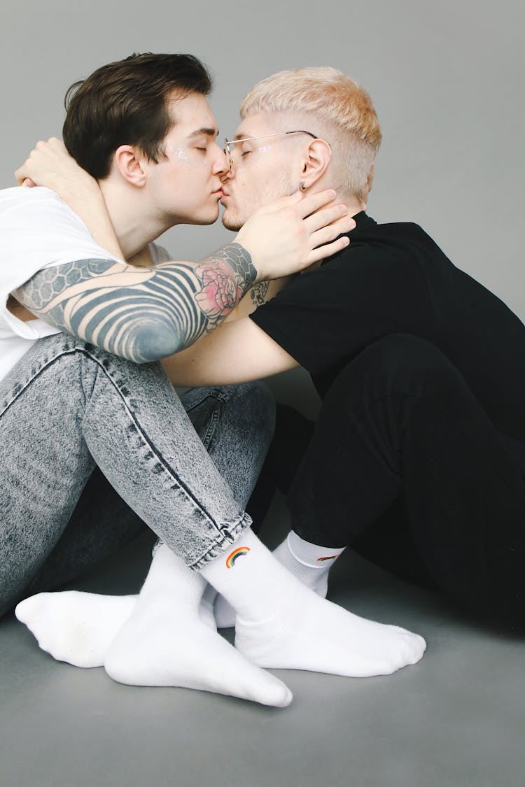 Men Sitting On The Floor And Kissing