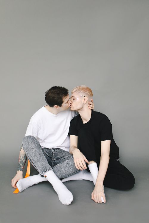 Free A loving couple shares a tender moment indoors with a neutral background. Stock Photo