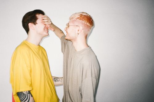 Free Two men sharing a playful, intimate moment indoors. LGBTQ+ love and happiness. Stock Photo