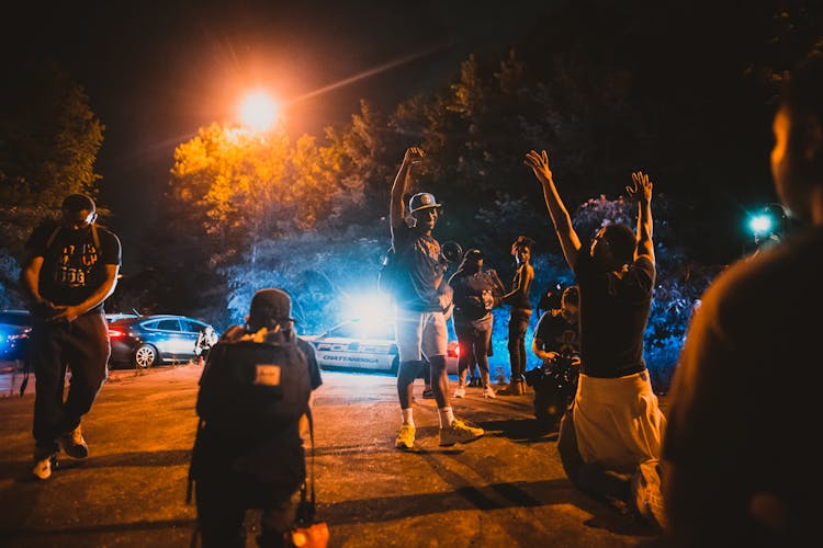 Black Men Standing On Street Near Journalists And Police Car During Anti Racism Demonstration