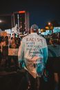 Unrecognizable people protesting on street at night during BLM movement