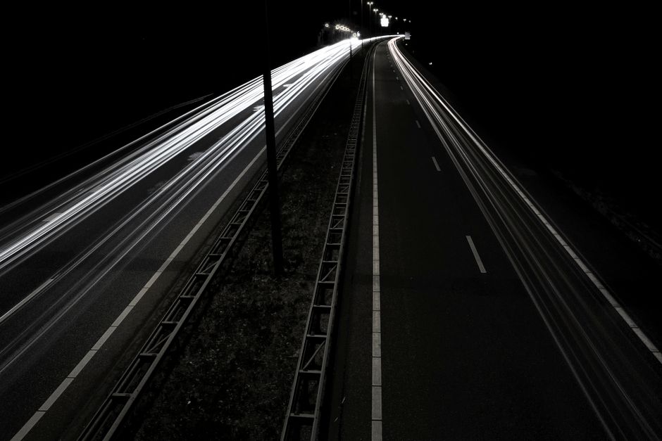 A captivating long exposure shot of highway light trails creating dynamic motion at night.