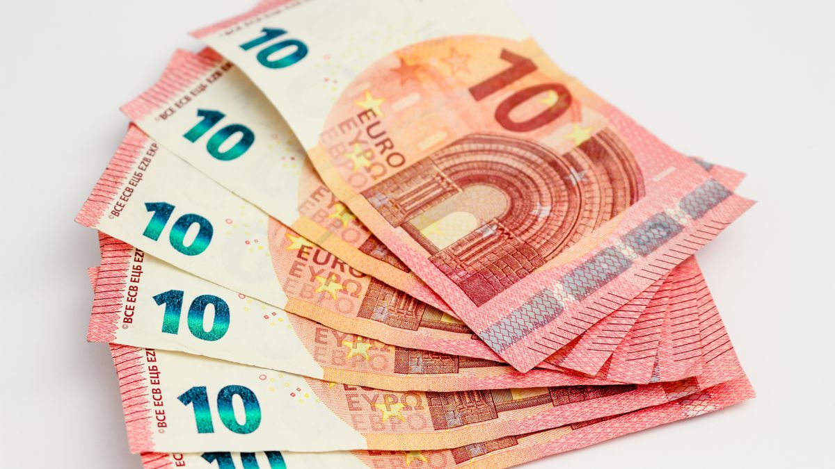 Close-up of a fan of 10 euro banknotes on a clean white background, showcasing European currency.