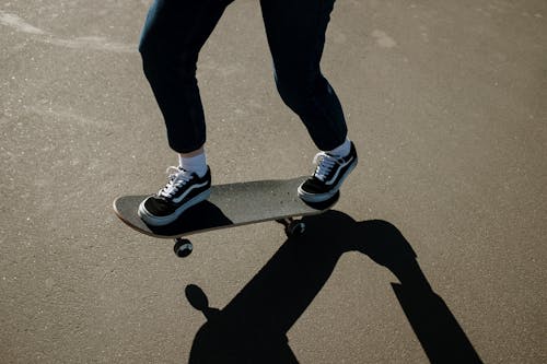 Person in Black Pants and Black and White Nike Sneakers