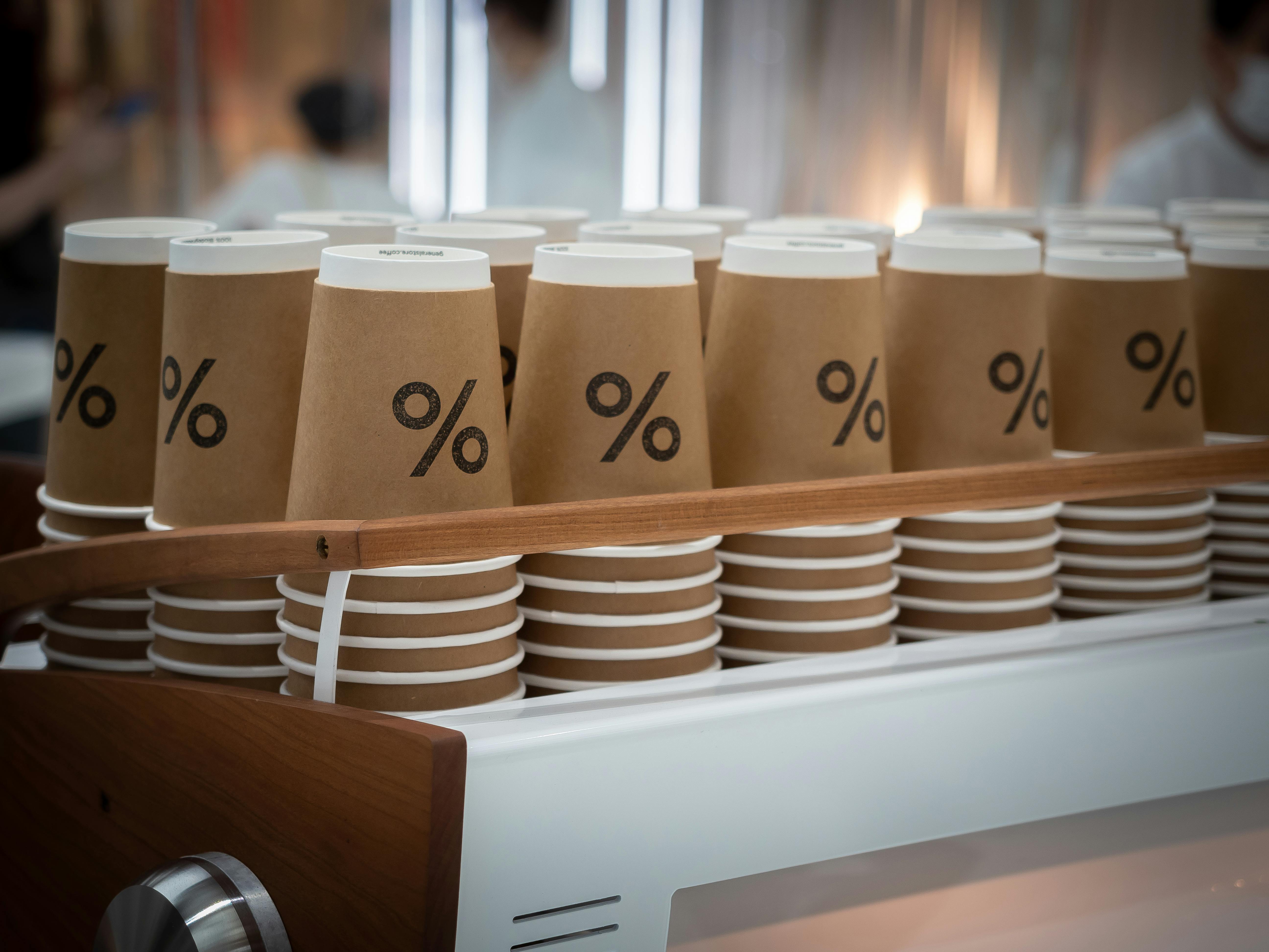 set of paper cups in contemporary cafe